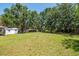 Expansive backyard with mature trees, a shed, and ample space for outdoor activities at 6226 Florence St, Gibsonton, FL 33534