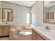 Unique bathroom featuring a corner tub and sinks on either side at 6226 Florence St, Gibsonton, FL 33534