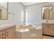 A unique bathroom featuring a corner tub and sinks at 6226 Florence St, Gibsonton, FL 33534