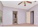 Neutral bedroom with a ceiling fan and adjacent bathroom at 6226 Florence St, Gibsonton, FL 33534