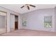 Neutral bedroom with a ceiling fan and closet with mirrored doors at 6226 Florence St, Gibsonton, FL 33534