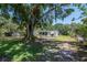Charming home featuring a screened-in porch and a spacious yard with mature trees at 6226 Florence St, Gibsonton, FL 33534