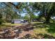 Charming home featuring a screened-in porch and a spacious yard with mature trees at 6226 Florence St, Gibsonton, FL 33534