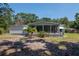 Charming home featuring a screened-in porch and lush landscaping at 6226 Florence St, Gibsonton, FL 33534