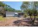 Charming home featuring a screened-in porch and mature landscaping at 6226 Florence St, Gibsonton, FL 33534