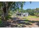 Charming home featuring a screened-in porch and a spacious yard with mature trees at 6226 Florence St, Gibsonton, FL 33534