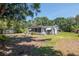 Charming home featuring a screened-in porch and a spacious yard with mature trees at 6226 Florence St, Gibsonton, FL 33534