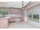 Eat-in kitchen with lots of light and desk area with drawers and upper cabinets at 6226 Florence St, Gibsonton, FL 33534