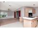 Open kitchen with island cooktop flows into the living room through doorway at 6226 Florence St, Gibsonton, FL 33534