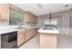 Kitchen with cooktop island, lots of light and wood cabinets at 6226 Florence St, Gibsonton, FL 33534