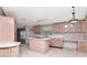 Kitchen with center island and light wood cabinets offers lots of storage at 6226 Florence St, Gibsonton, FL 33534