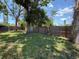 Spacious backyard with lawn and mature trees, and a wood fence at 6741 4Th Ave N, St Petersburg, FL 33710