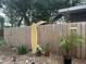 Fenced backyard featuring a surfboard, palm tree, and gravel at 6741 4Th Ave N, St Petersburg, FL 33710