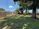 Large backyard with a patio area, mature trees, and wood fence at 6741 4Th Ave N, St Petersburg, FL 33710