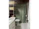 Bathroom with granite countertop, white tile floor, monstera shower curtain and open shelving at 6741 4Th Ave N, St Petersburg, FL 33710