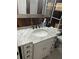 Bathroom features a vanity with a white marble countertop and wood plank accent wall at 6741 4Th Ave N, St Petersburg, FL 33710