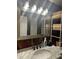 Bathroom vanity with granite countertop, rustic mirror, and storage shelves at 6741 4Th Ave N, St Petersburg, FL 33710