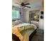 Comfortable bedroom offers a ceiling fan, natural light, and ample storage space at 6741 4Th Ave N, St Petersburg, FL 33710