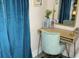 Bedroom featuring vanity area with plush velvet chair and blue curtains at 6741 4Th Ave N, St Petersburg, FL 33710