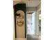 Hallway view leading to bathroom with decorative shelving and arched doorway at 6741 4Th Ave N, St Petersburg, FL 33710