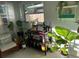 Sunlit living room featuring a bookshelf, plants, and neutral decor at 6741 4Th Ave N, St Petersburg, FL 33710