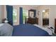 Comfortable bedroom featuring two windows, a dresser with mirror and an ensuite bathroom at 7001 Interbay Blvd # 242, Tampa, FL 33616