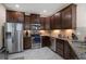 Well-equipped kitchen with stainless steel appliances, granite countertops, and stylish dark wood cabinetry at 7001 Interbay Blvd # 242, Tampa, FL 33616