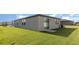 Spacious backyard with lush lawn and modern exterior. Perfect for outdoor activities and relaxation at 7119 Amelia River Dr, Parrish, FL 34219