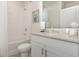Bathroom featuring a shower-tub, white cabinets and modern granite countertop, showcasing contemporary finishes at 7119 Amelia River Dr, Parrish, FL 34219