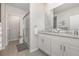 Modern bathroom features double sinks, granite countertops, and a glass-enclosed shower at 7119 Amelia River Dr, Parrish, FL 34219