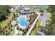 Aerial view of the community clubhouse with a large swimming pool, cabanas, and meticulously landscaped surroundings at 7119 Amelia River Dr, Parrish, FL 34219