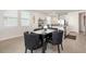 Bright dining area with a table for four and a view of the open kitchen and living spaces at 7119 Amelia River Dr, Parrish, FL 34219