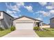 Inviting home featuring a two-car garage, manicured lawn, and beautiful landscaping at 7119 Amelia River Dr, Parrish, FL 34219