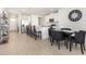 Modern kitchen with white cabinets, stainless steel appliances, and a breakfast bar with seating at 7119 Amelia River Dr, Parrish, FL 34219