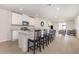 Bright kitchen with white cabinetry, stainless steel appliances, and a center island with bar seating at 7119 Amelia River Dr, Parrish, FL 34219