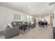 Open-concept living space with neutral decor, wood-look tile flooring, and ample natural light at 7119 Amelia River Dr, Parrish, FL 34219