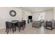 Open-concept living and dining area with contemporary furnishings and modern decor at 7119 Amelia River Dr, Parrish, FL 34219