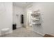 Well-organized walk-in closet with shelving, hanging space, and carpet flooring at 7119 Amelia River Dr, Parrish, FL 34219