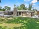 Spacious backyard featuring a well-maintained lawn, a screened in patio, and a neutral exterior color scheme at 7137 Wedgewood Dr, New Port Richey, FL 34652