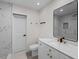 Modern bathroom with white marble countertop vanity and tiled walk-in shower at 7137 Wedgewood Dr, New Port Richey, FL 34652
