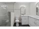 Bathroom with double sinks, sleek mirrors, walk-in shower, and modern black and white tiled floor at 7137 Wedgewood Dr, New Port Richey, FL 34652
