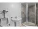 Retro bathroom featuring unique pedestal sink, a shower with glass doors and a urinal at 7137 Wedgewood Dr, New Port Richey, FL 34652
