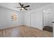 Vacant room featuring light hardwood floors, a ceiling fan, and lots of closet space at 7137 Wedgewood Dr, New Port Richey, FL 34652