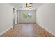 Bedroom featuring light wood-look flooring, a window, and a sliding barn door to the closet at 7137 Wedgewood Dr, New Port Richey, FL 34652