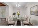 Bright dining room boasts a glass table with seating for ten, with modern decor at 7137 Wedgewood Dr, New Port Richey, FL 34652