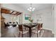 Open-concept dining area with wood beam ceiling details adjacent to the living room at 7137 Wedgewood Dr, New Port Richey, FL 34652