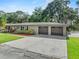 Lovely single-story home featuring a long driveway, lush landscaping, complemented by mature trees at 7137 Wedgewood Dr, New Port Richey, FL 34652