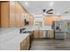 Modern kitchen features stainless steel appliances, light wood cabinets and bright, marble countertops at 7137 Wedgewood Dr, New Port Richey, FL 34652