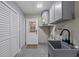 Convenient laundry room with utility sink, washer/dryer hookups and plenty of storage space at 7137 Wedgewood Dr, New Port Richey, FL 34652