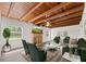 Staged living room with wood beam ceiling, brick fireplace, and contemporary furnishings at 7137 Wedgewood Dr, New Port Richey, FL 34652